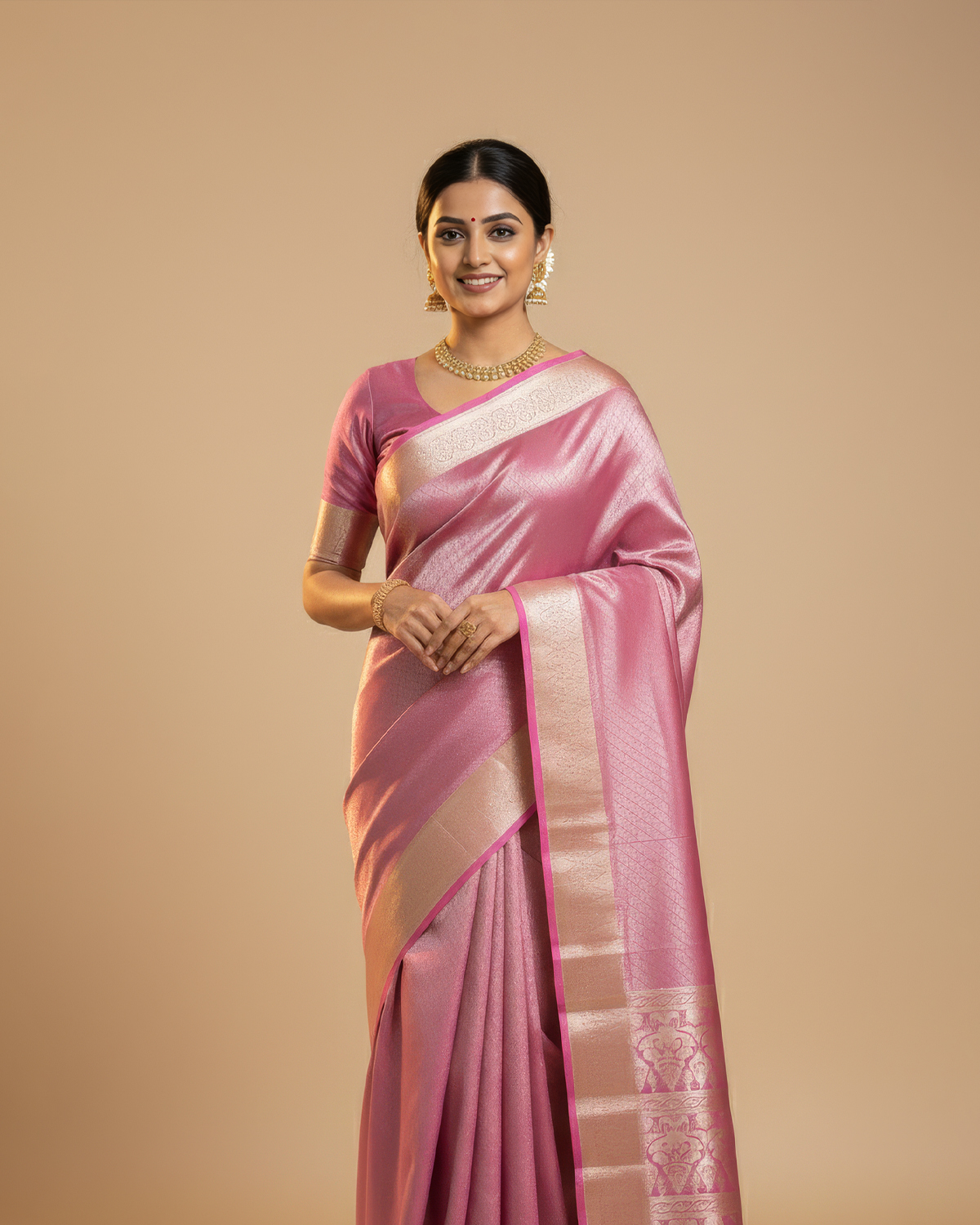 Model wearing a dusty rose soft silk saree with an ivory woven border